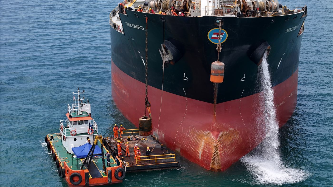 Tug working alongside a tanker's bow